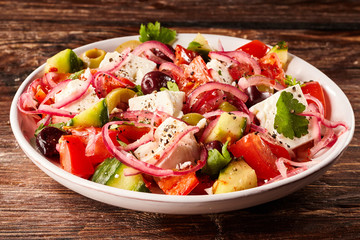 Small bowl of olive and tomato salad with herbs
