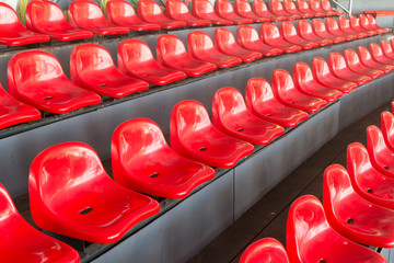 Naklejka na ściany i meble red plastic chairs of old sport stadium