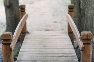 Fototapeta na wymiar wooden bridge in Park on background of green grass