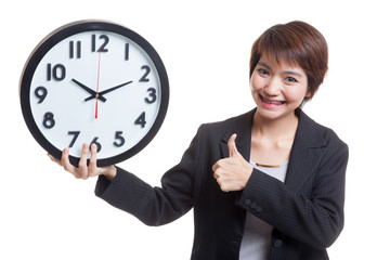 Young Asian business woman thumbs up with a clock.
