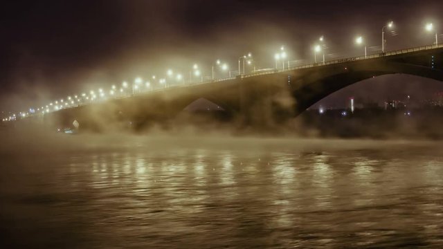 Road bridge and rising mist over the river Yenisei in the night light, Time Lapse Of Bridge In Winter, Krasnoyarsk, Russia