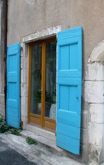 Old building with blue shutters. Ganges, Occitanie, southern France