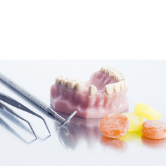 Dental impression with mirror, tweezers and some sweets