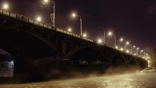 Road bridge and rising steam over the river Yenisei in the night light, Time Lapse Of Bridge In Winter, Krasnoyarsk, Russia