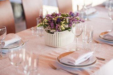    table setting in restaurant with flowers and wineglasses