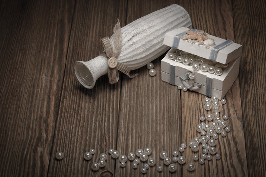 Casket with pearls on a wooden background