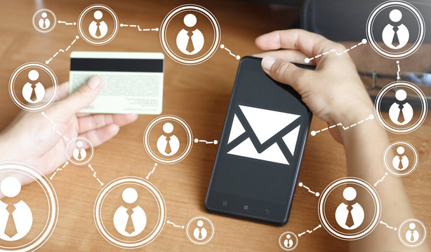 businessman keep smart phone with mail sign. Smartphone with envelope icon in one hand and credit card in other hand. Mail in business, email, post, chat, communication. Bank card, gift card, network.