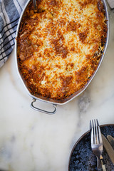 Stuffing casserole dish over marble table. Top view.