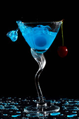 Splashing cocktail with cherry