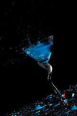 Blue cocktail splash and cherry