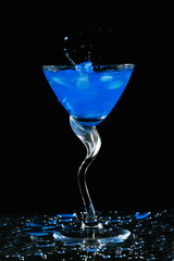 Ice cube dropping into cocktail