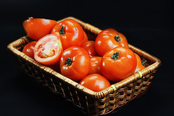 Basket with ripe red tomatoes