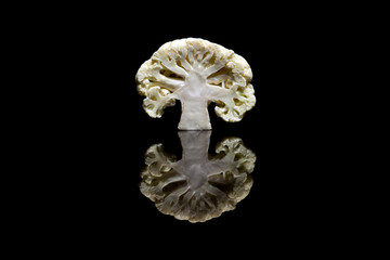 Cut in half white cauliflower isolated on black background