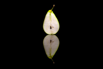 Cut in half one pear isolated on black background