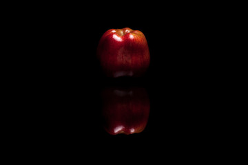 Red apple isolated on black background