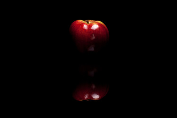 Red apple isolated on black background