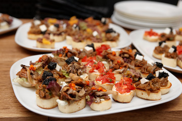 Bruschettas with meat and soft cheese