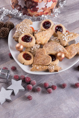 Christmas cookies with stars and presents on wooden table