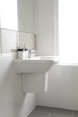 Fototapeta na wymiar White sink and dispenser in bathroom