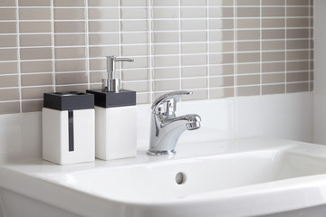 White sink and dispenser in bathroom