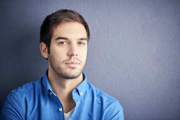 Close-up portrait of a handsome young man looking at camera