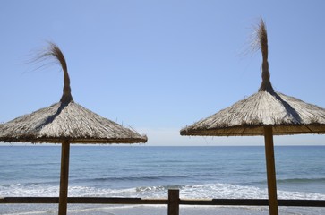 Straw umbrellas in Marbella, Spain