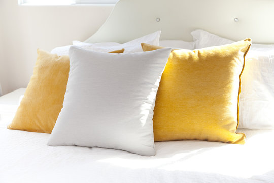 Comfortable White And Yellow Pillow On Bed