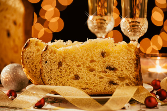 Closeup of sliced italian panettone and sparkling wine