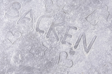 bakery background with cookie cutter and flour