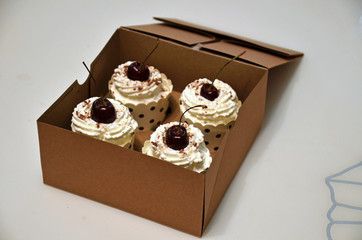 Cupcakes with cream top in a box