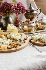 A beautiful table setting. Different varieties of cheeses.