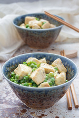 Fried chicken with green peas in cream sauce, served with rice, vertical