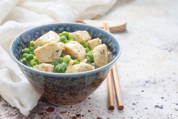 Fried chicken with green peas in cream sauce, served with rice, horizontal, copy space