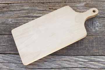 Wooden chopping board on background