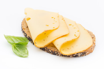 Cheese slices on bread. White background.