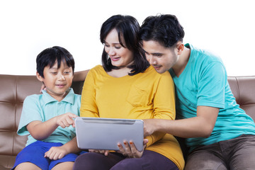 Happy family with tablet on sofa