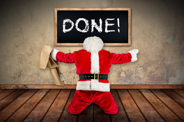 classic red white Santa Claus with empty bag celebrating on his knees the work is done ready for...