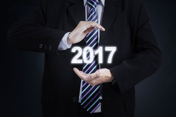 Male entrepreneur holds number 2017