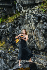 Girl in a black suit with flaming torches .
