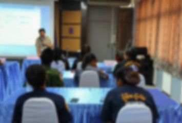 blurred focus, student learning business sitting in classroom with teacher front 