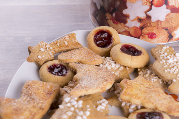 christmas cookies with stars and present on wooden background