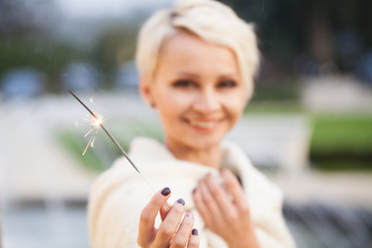 beautiful woman holding sparklers