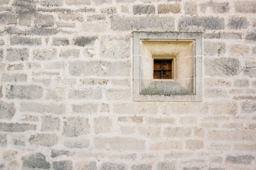 Wall of sandstone with little window