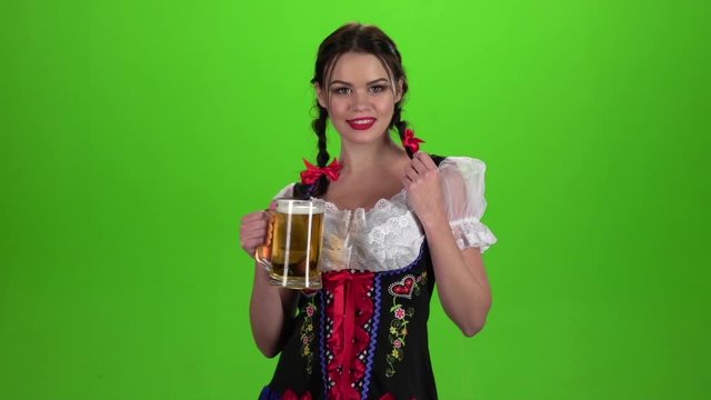 Girl Oktoberfest sexually attracts and licks his lips. Green screen