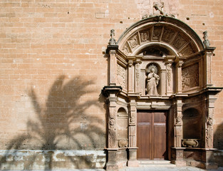 Facade of church with shadow of palm tree