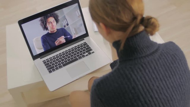 The girl talks in Skype to the client