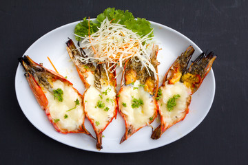Baked Giant River Prawn with cheese, Top view on black backgroun