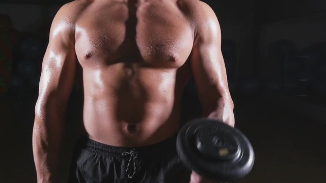 Muscular Bodybuilder Guy Doing Exercises With Dumbbells