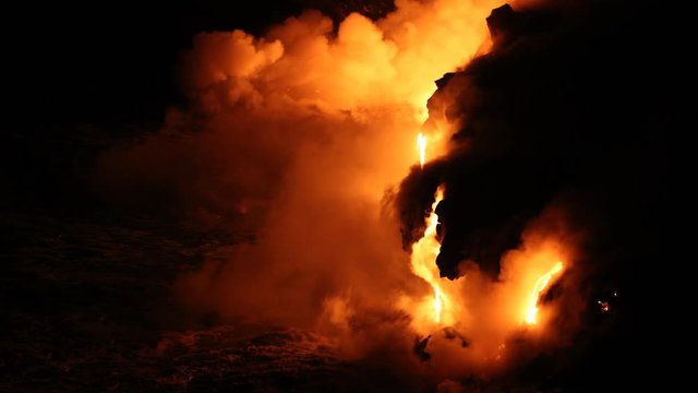 Hawaii Lava ocean - flowing lava reaches ocean on volcanic eruption on Big Island, Hawaii. Lava stream flowing from Puu Oo, Kilauea volcano by Hawaii volcanoes national park, USA. Night shot 59.94 FPS