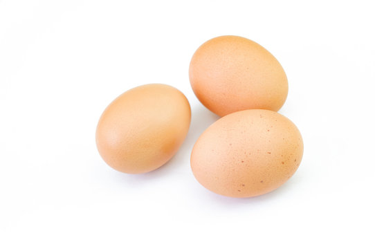 Three brown raw eggs isolated on white background